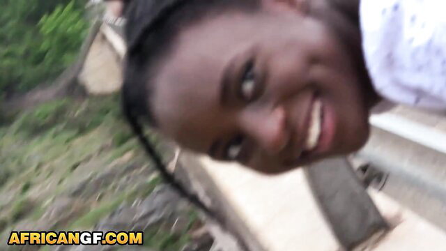 Smiling black babe in white top hanging off bench in outdoor interracial setup