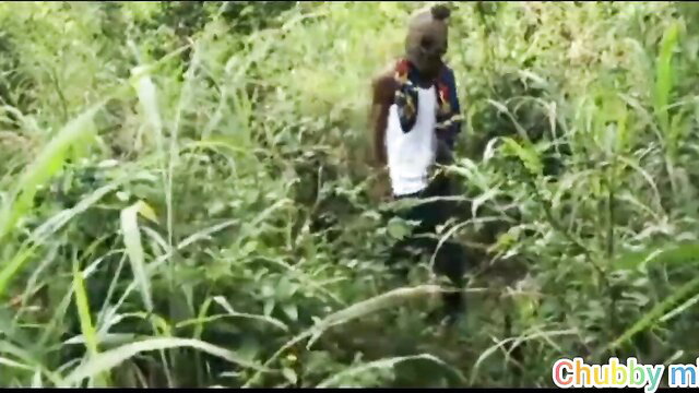 African man in village bush with mask, tank top, hardcore outdoor tease