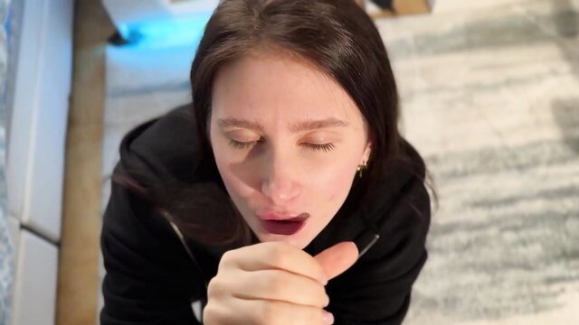 Brunette on knees POV pointing at open mouth after practice cock treat