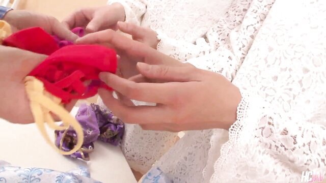 Japanese women hands holding red lacy lingerie in JAV tease