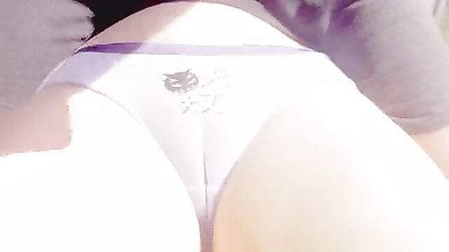 Closeup of woman's tight white panties pulled aside exposing shaved pussy