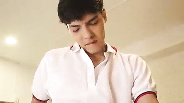 Handsome Latino guy in white polo shirt smirks teasingly close-up