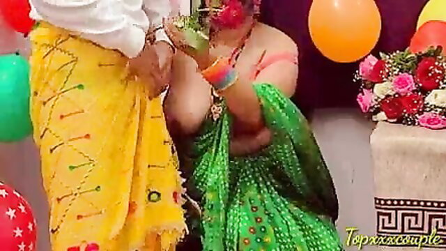 Indian bride in yellow saree kneels for groom in white dhoti at wedding