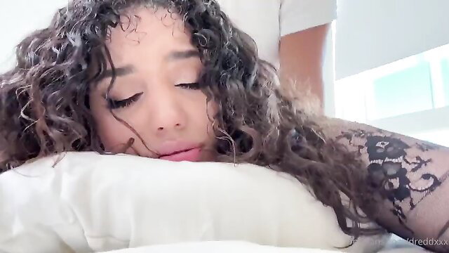 Gem Jewels resting seductively on bed with tattoos, hot friend vibe