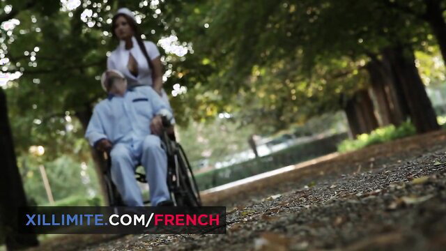 Anna Polina big boobs nurse pushes old man in wheelchair outdoors