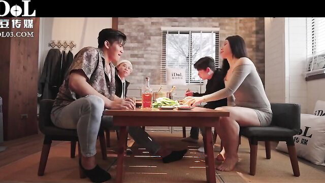 Asian family at dinner table in casual home setting