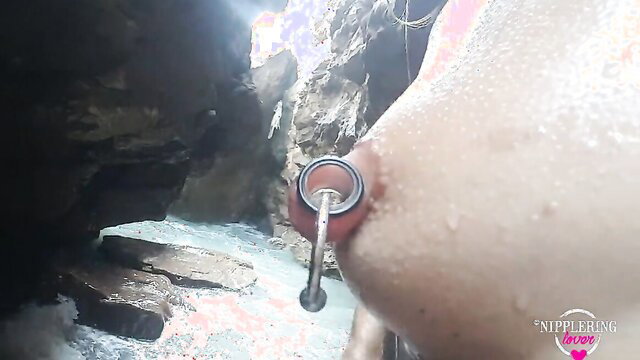 Nippleringlover's stretched nipple ring closeup at nude beach