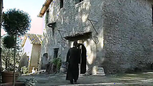 Jessica Rizzo as sexy nun in La monaca di Monza, walking in black habit