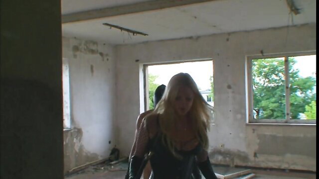 Blonde in latex catsuit groped by man in BDSM scene