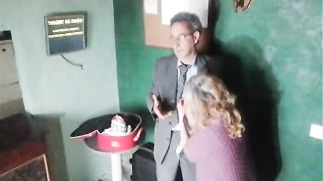 Mr. Gresopio chats with mature blonde woman by birthday cake on airplane trip