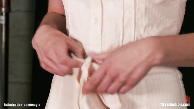 TS in white dress tying belt, teasing seduction closeup