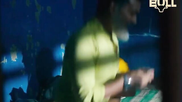 Mature Indian man in yellow shirt in dim blue-lit room, Chhatari Short Film