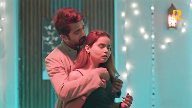 Indian couple intimate embrace, man hugs redhead woman from behind