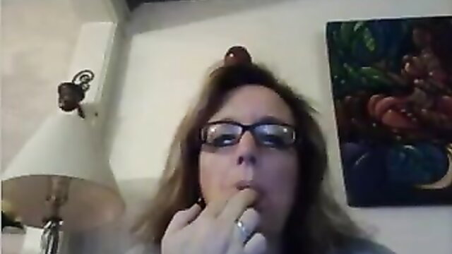 Messy haired ugly brunette mature with glasses fingers mouth closeup