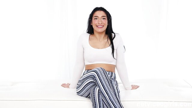 Smiling fitness instructor with incredible body in crop top and pants