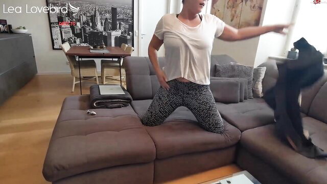 Lea Lovebird teases in sheer top and leggings on couch