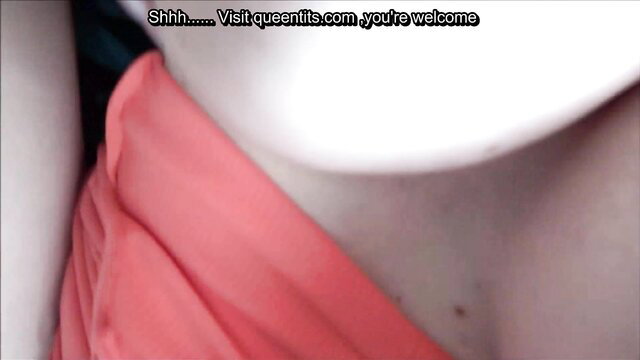 Closeup of woman's neck and pink dress in Gloryhole Secrets video