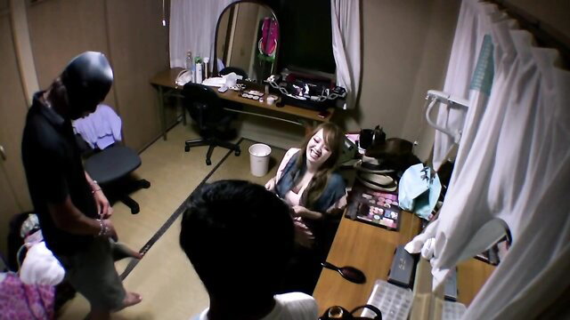 Hitomi Tanaka JAV threesome with two men in bedroom