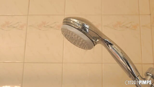 Liv Revamped holds showerhead in steamy bath, petite exotic tease