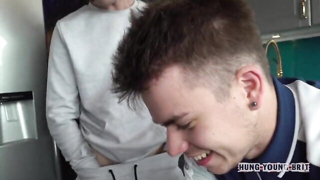 Hung Young Brit twink laughing as buddy grabs his bulge in kitchen