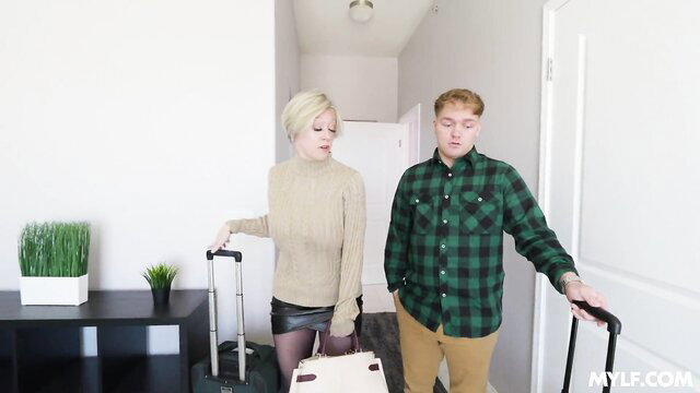Blonde stepmom in skirt stockings with redhead stepson by luggage