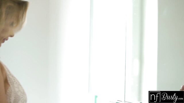 Big tit blonde in lace lingerie poses seductively by mirror