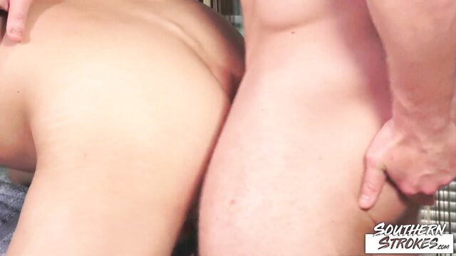 Two nude women bent over with man grabbing asses in steamy massage