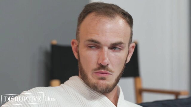 Balding bearded white guy in robe on amateur porn set