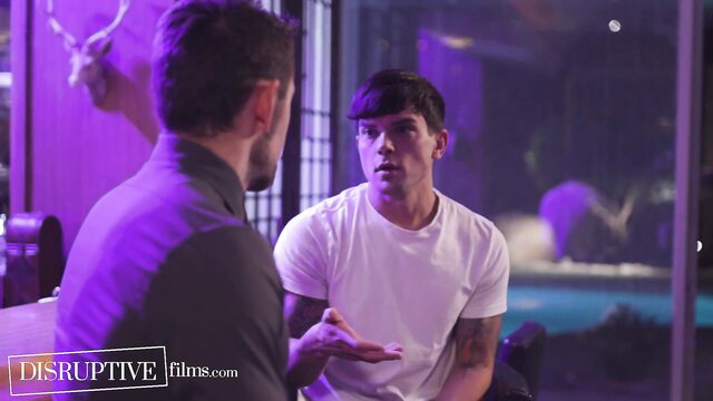Two handsome tattooed men in intimate convo, white tee and shirt