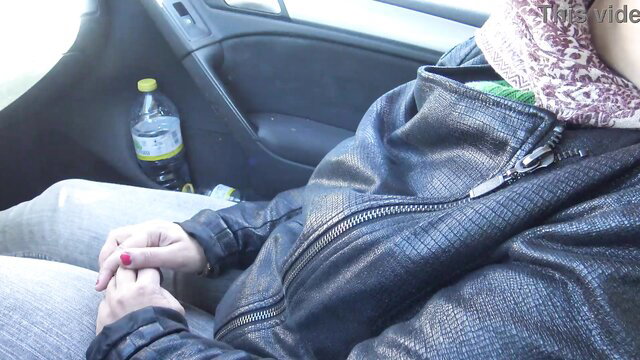 Algerian girl in leather jacket holds small cock in car handjob