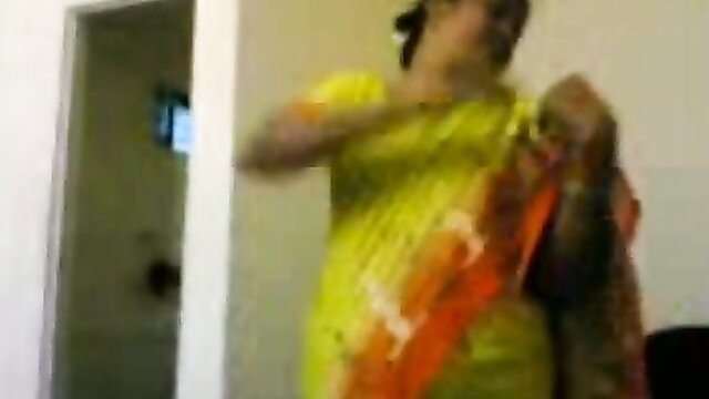 Amateur Indian housewife in yellow saree adjusting outfit, flashing ugly natural tits