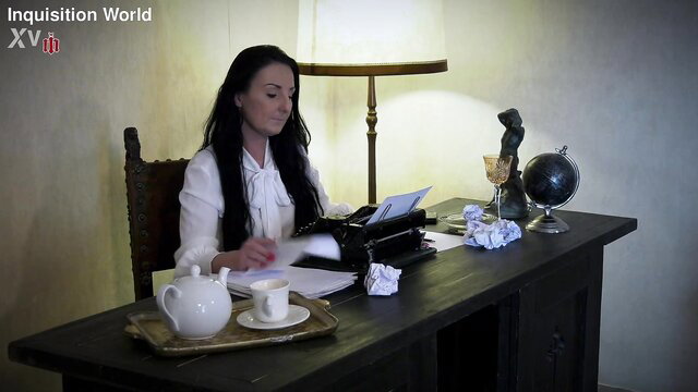 Sexy brunette maid typing at desk in Inquisition World ordeal trailer
