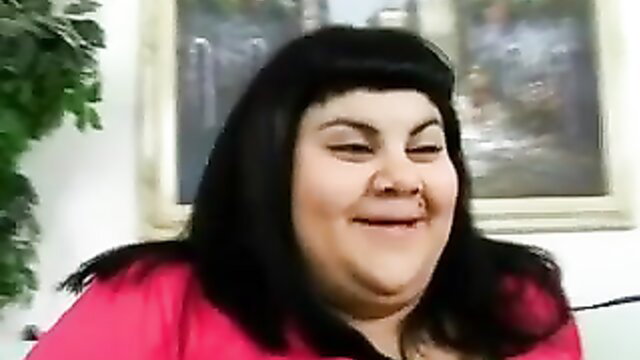 Obese black haired BBW chick smiling closeup in pink top