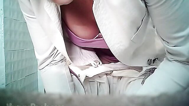 Mature blonde in white suit exposing huge tits and pink bra in restroom