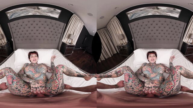 Tiger Lilly tattooed alt model nude on bed, legs spread wide