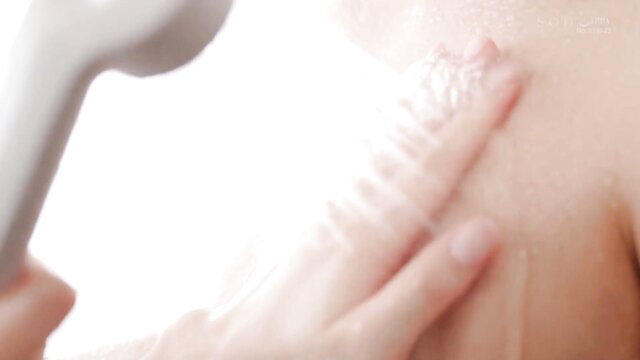 Asian woman showering, soaping wet nude body sensually closeup