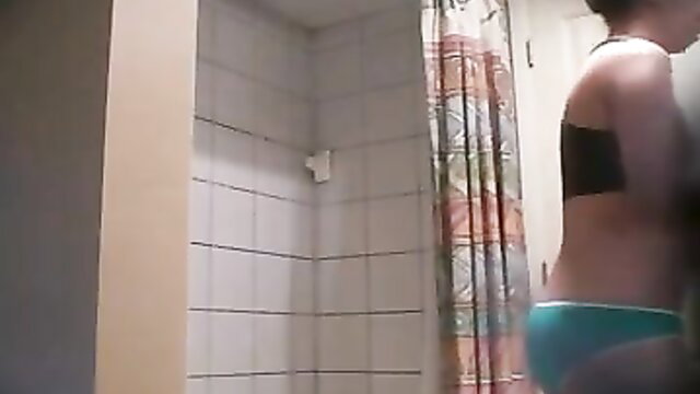 Amateur brunette in black bra and green panties in shower hidden cam