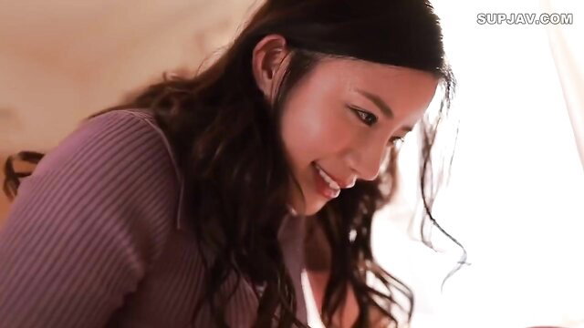 Maria Nagai smiling seductively in tight purple sweater, JAV closeup