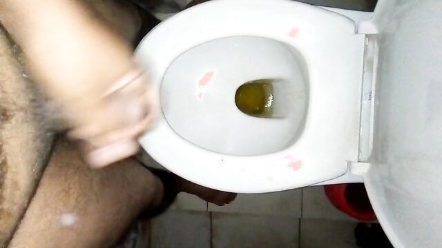 Black horny boy pissing in toilet with thick cum dripping visibly