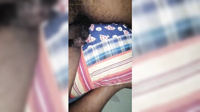 Blurry closeup of dark-skinned man's crotch in colorful plaid underwear