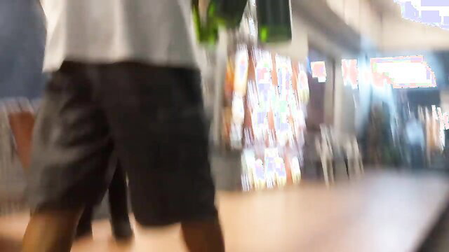 Blurry amateur public pickup couple walking in neon-lit arcade