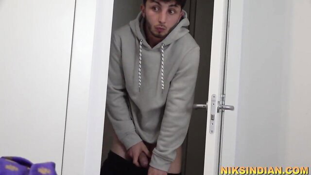 Indian twink in hoodie pulls down pants exposing cock at door
