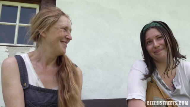 Two Czech country girls in overalls smile outside, amateur public pickup