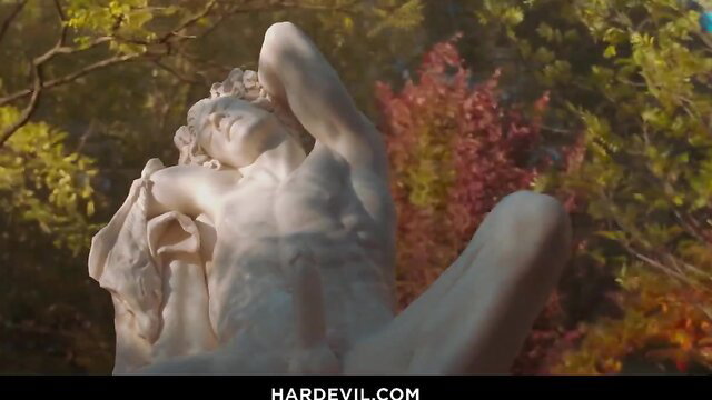 Nude male statue in forest, muscular body erotic pose