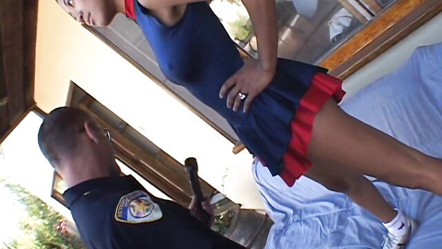 Lily Thai cheerleader in navy red uniform with cop holding baton