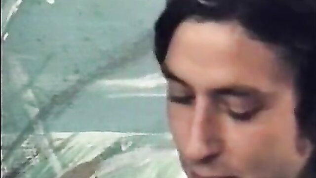 Closeup of man with intense gaze in vintage Color Climax Discotheque Sex scene