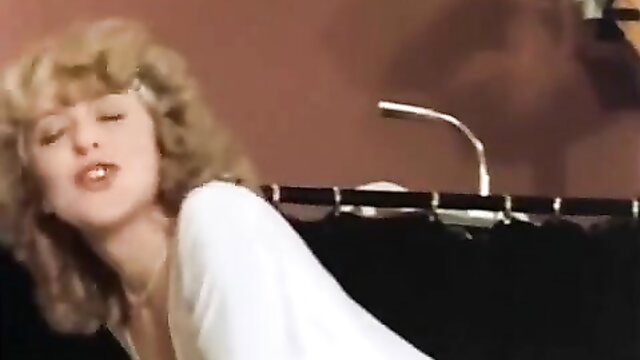 Blonde babe in white dress moaning passionately in vintage Disco Passion scene