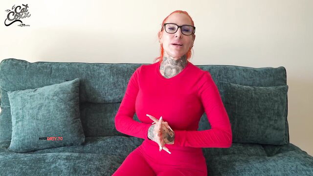 Redhead tattooed babe Cat-Coxx in tight red bodysuit, glasses