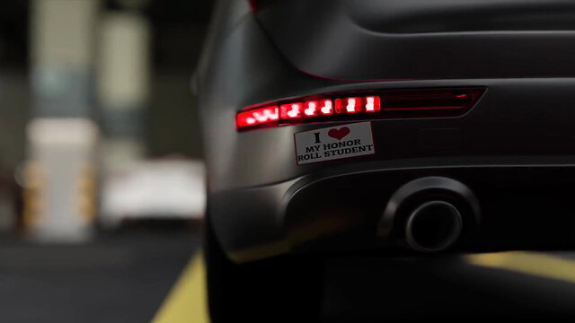 Car with 'I heart my holy student' bumper sticker, dark night parking