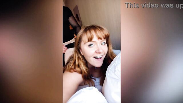 Redhead amateur in bed smiling with man, intimate couple moment